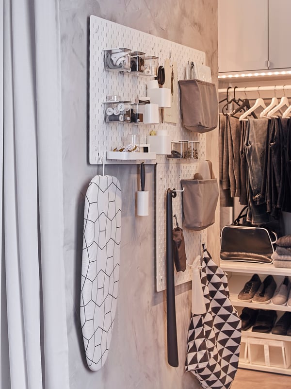 SKÅDIS pegboards and accessories, such as hooks, hang on a narrow wall, where they store and organise clothing care items.