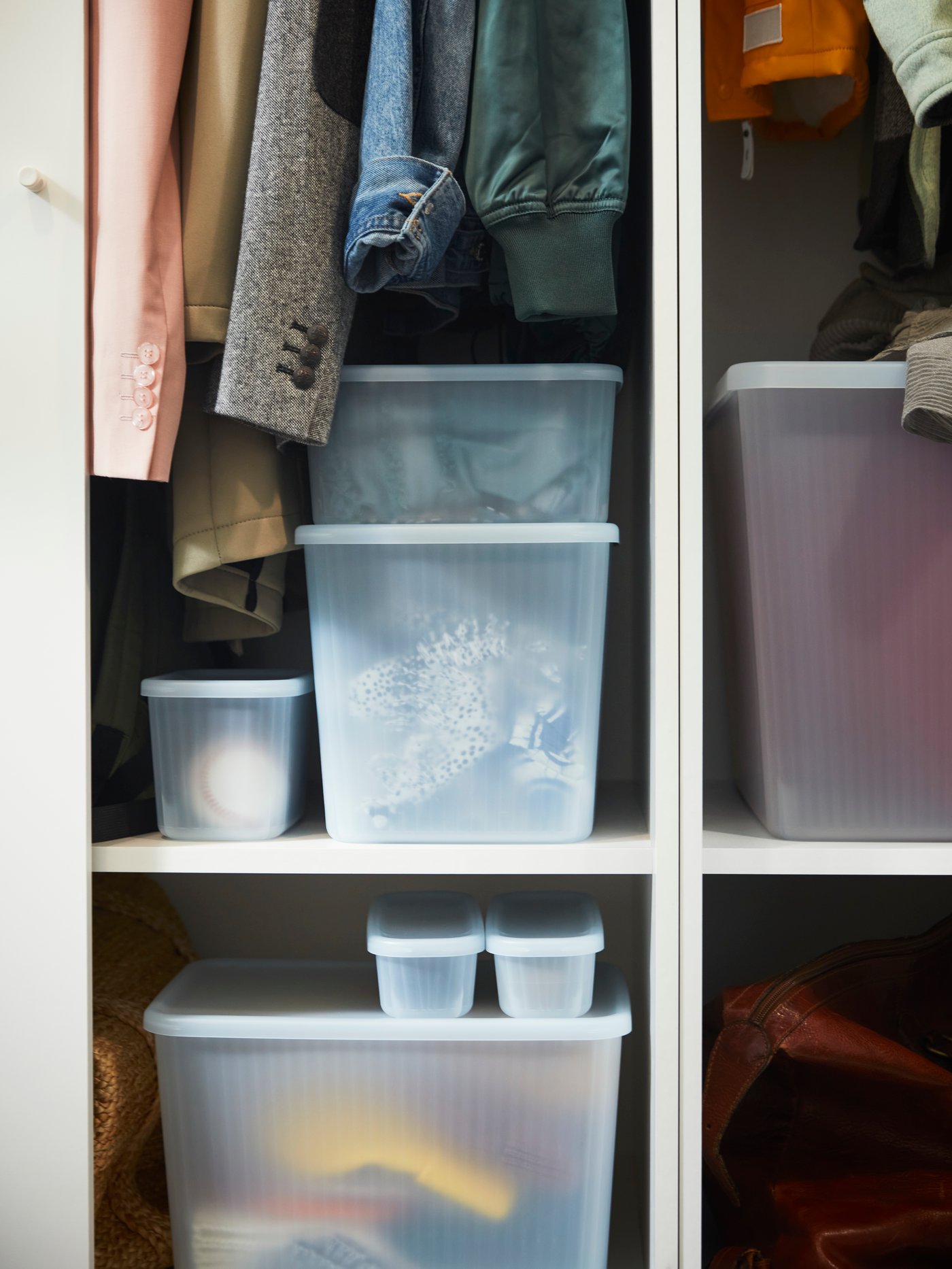 Storage boxes that are stacked high in white colour.