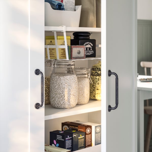 White cabinet containing various types of tea