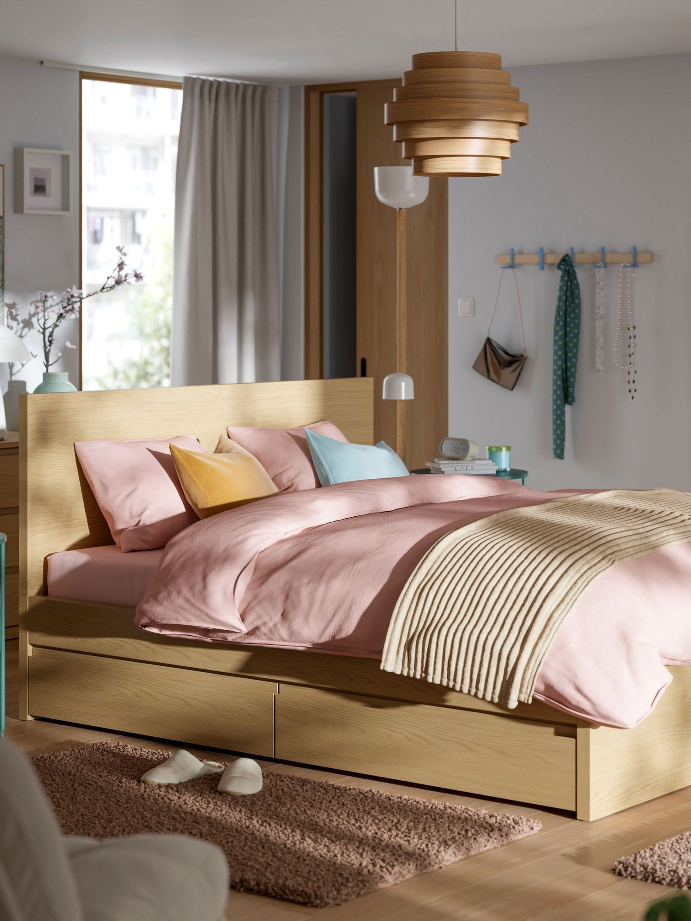An oak effect/Leirsund STORKLINTA bed frame with 2 storage boxes