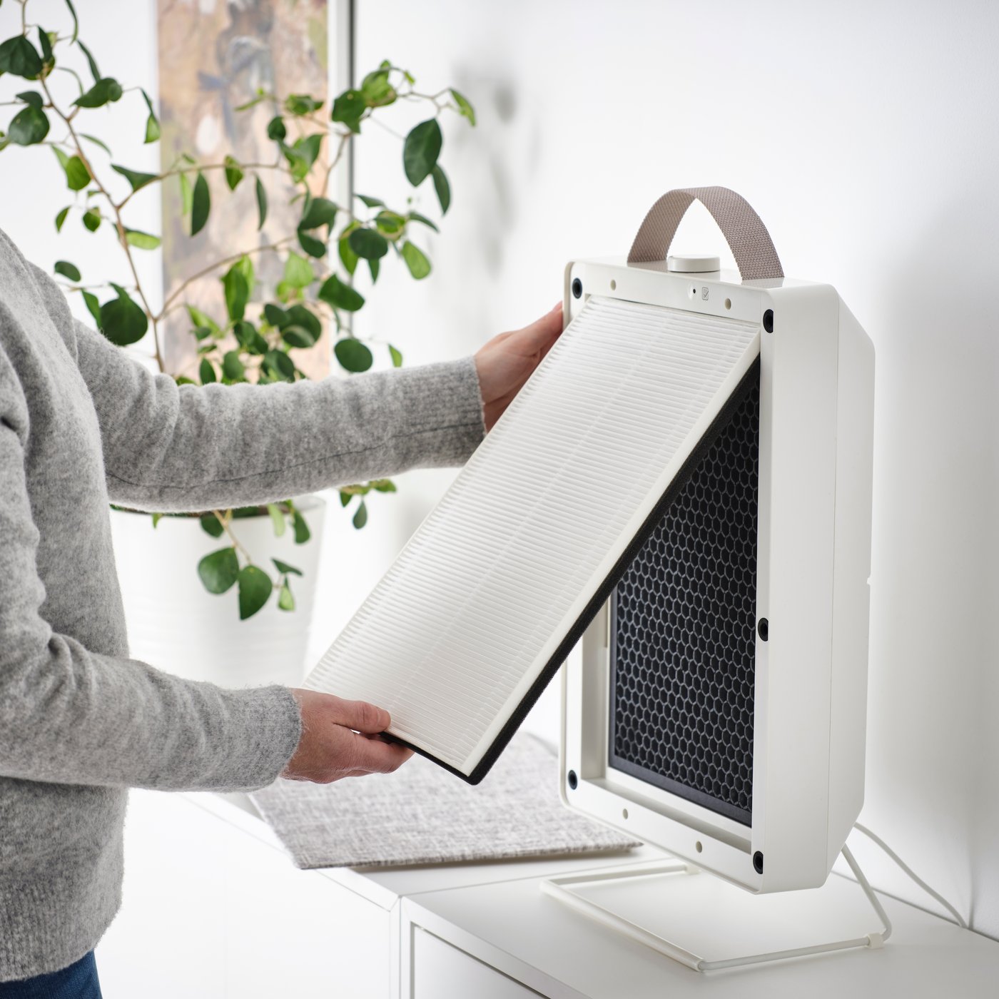 A white FÖRNUFTIG air purifier in the home office