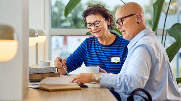 An interior designer from IKEA helps a business customer plan a design project.