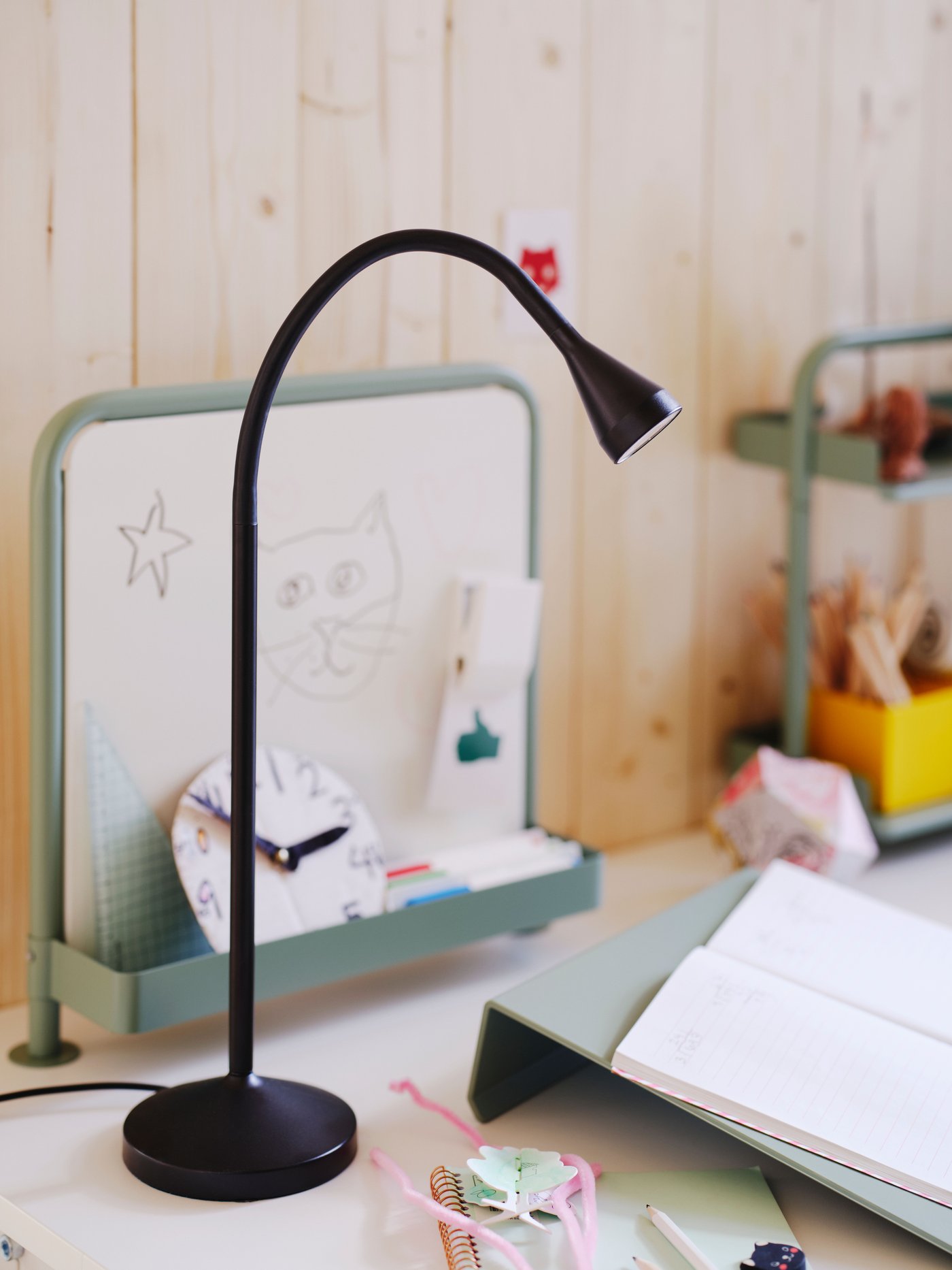 A light grey-green RELATERA desk top shelf in the childrens room