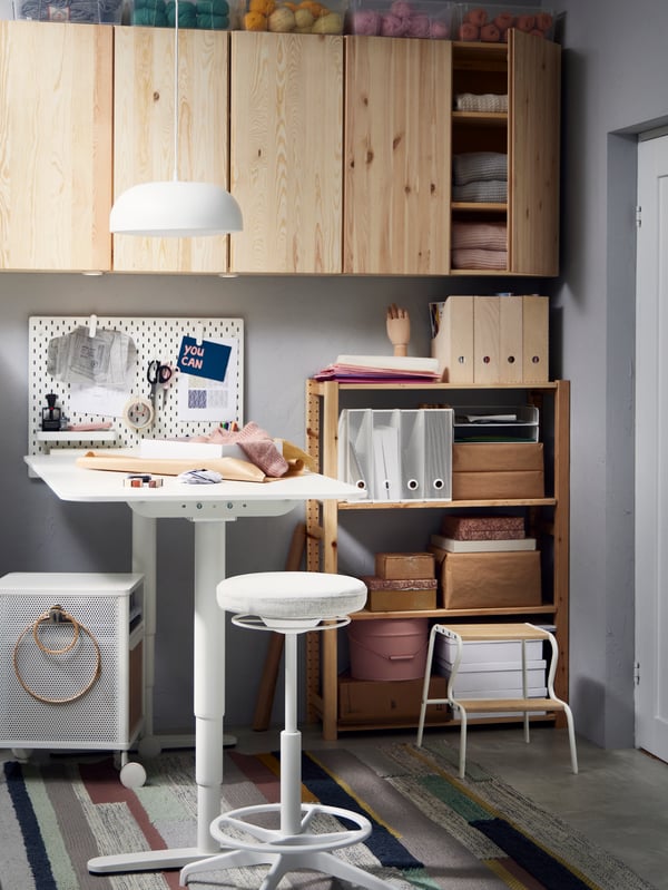 A diy corner with IVAR cabinets on the wall and a working station