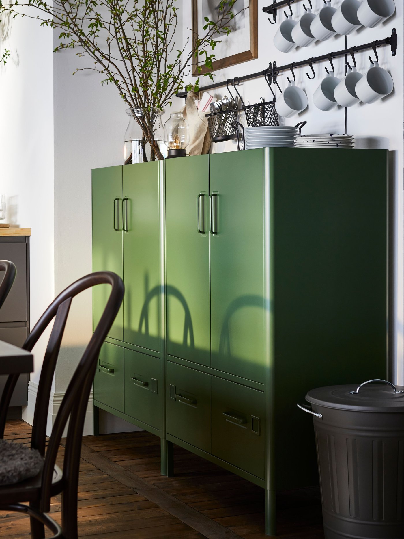 A dark green IDÅSEN cabinet with doors and drawers