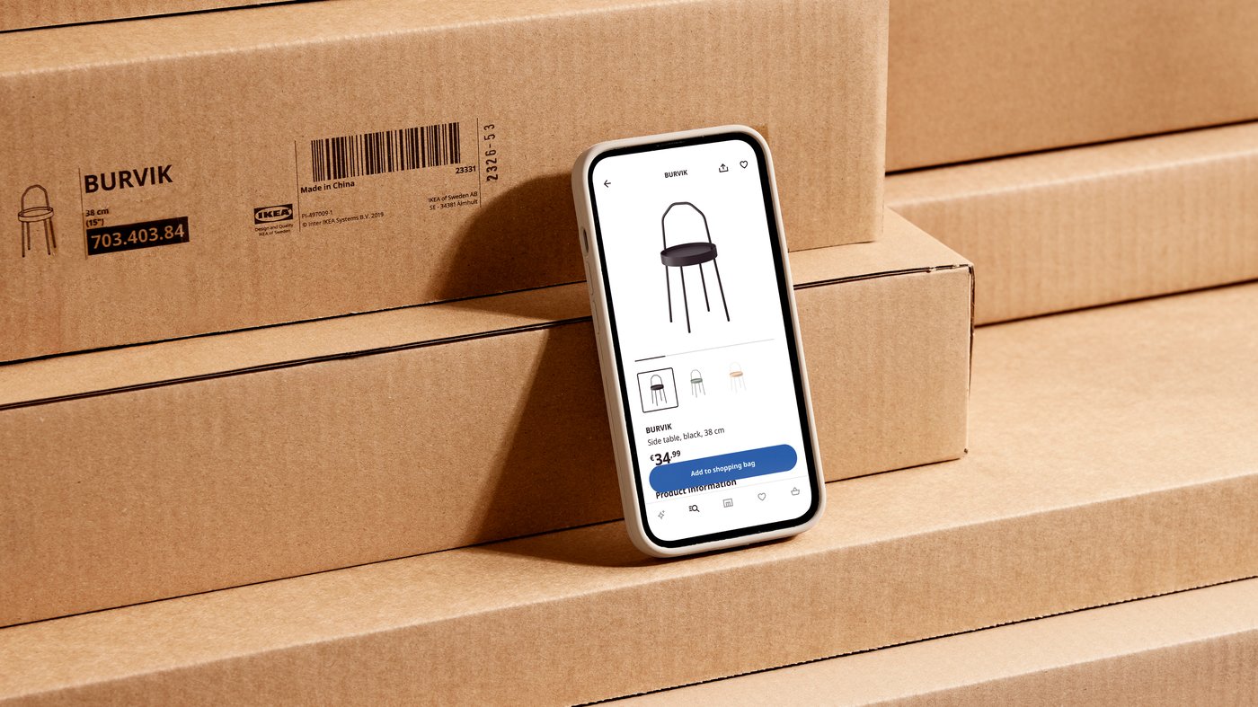 smartphone with the IKEA app open, lying on cardboard boxes