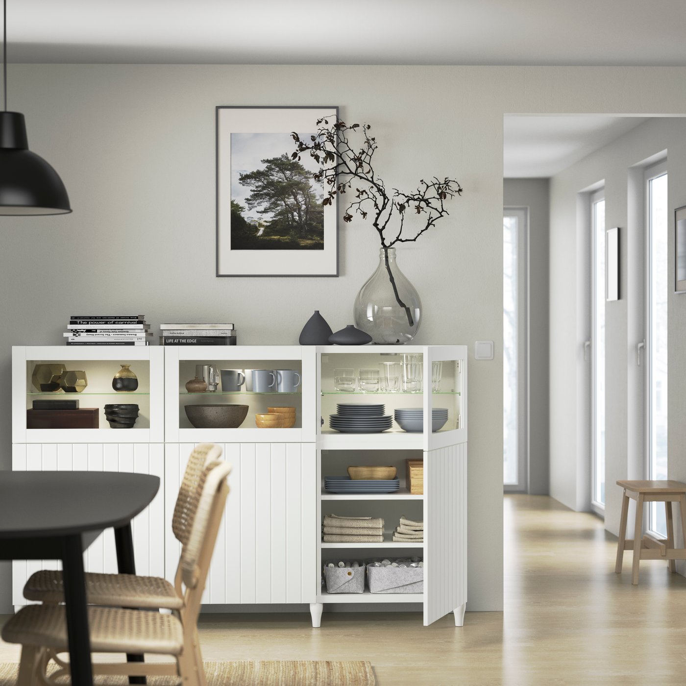 A white/Sutterviken/Kabbarp white clear glass BESTÅ storage combination with doors in the dining room