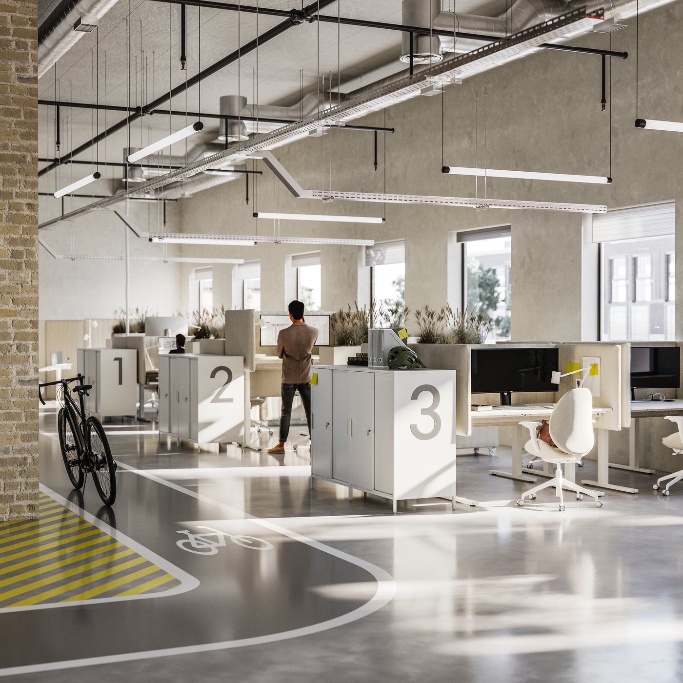 Tres filas de escritorios en una oficina abierta y luminosa. Cada estación de trabajo cuenta con paneles acústicos y asientos ergonómicos.