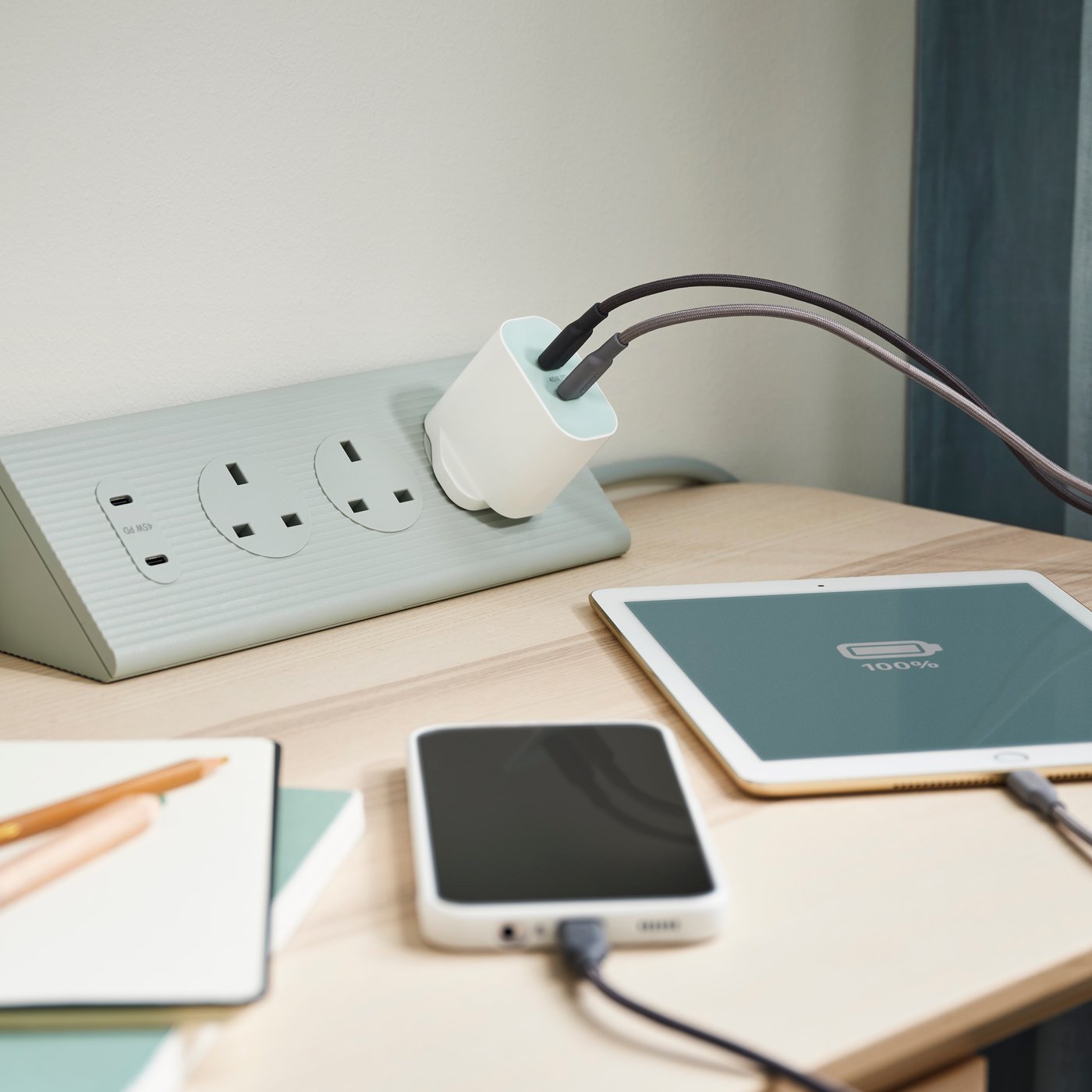 A green SKOTAT extension cord