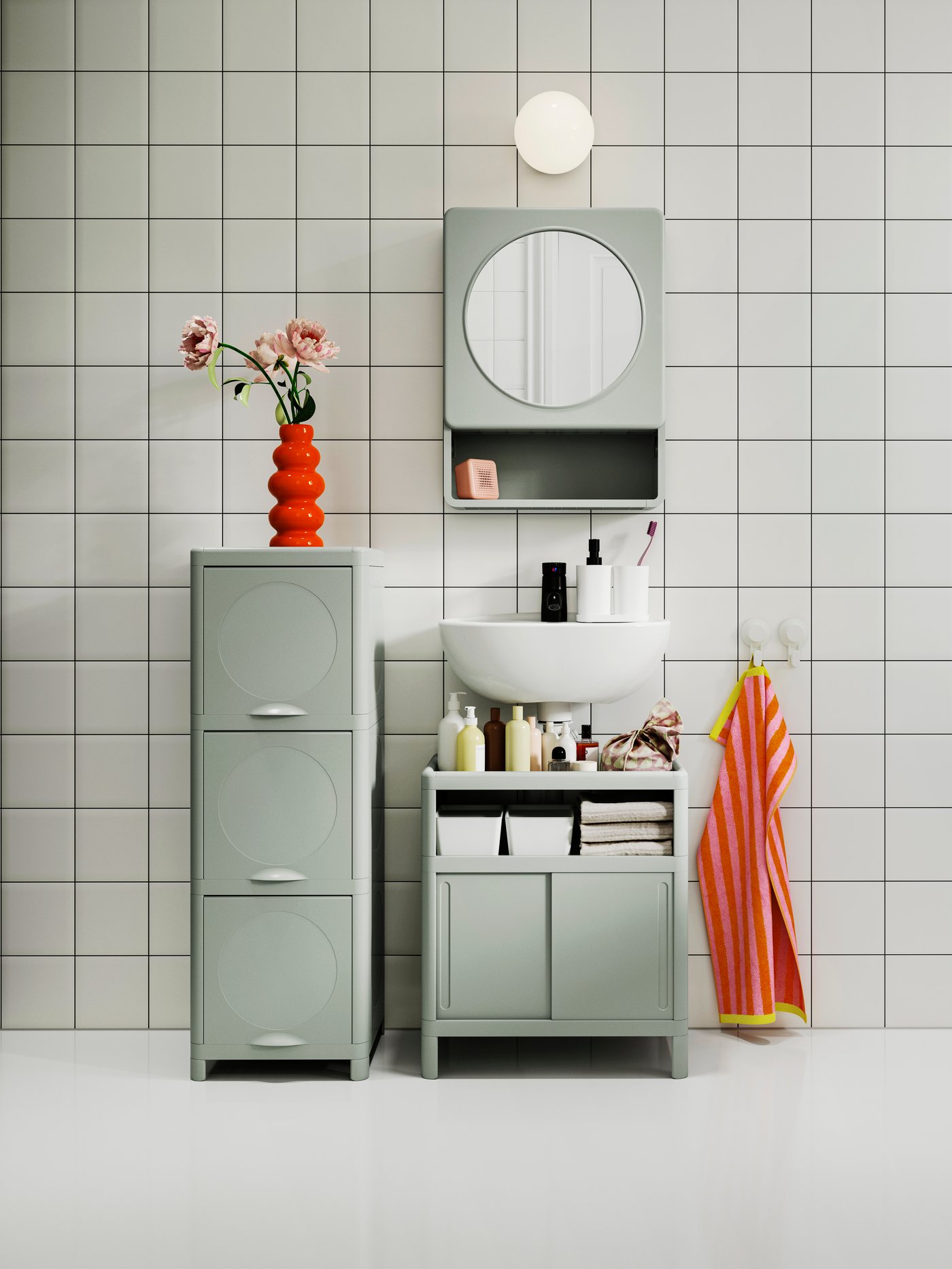 A green IVÖSJÖN cabinet with doors in the bathroom