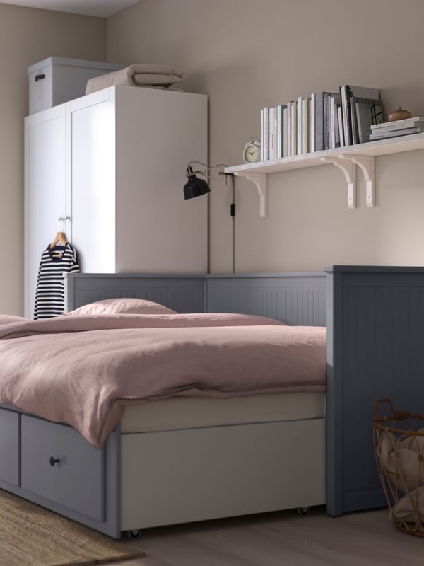 A white/high-gloss LACK wall shelf in the bedroom