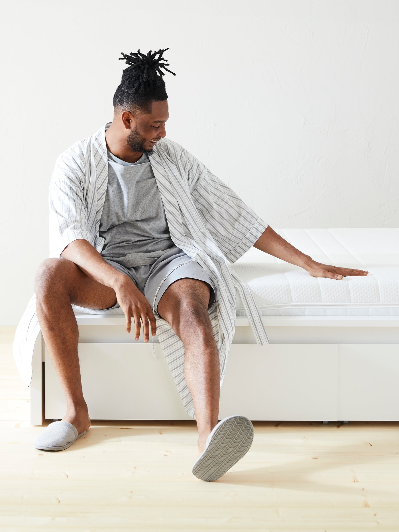 A firm/white ÅKREHAMN foam mattress in the bedroom