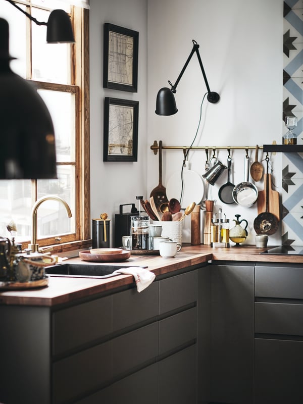 A black SKURUP work/wall lamp in the kitchen
