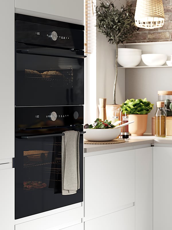 A microwave oven and a microwave combination in a white kitchen