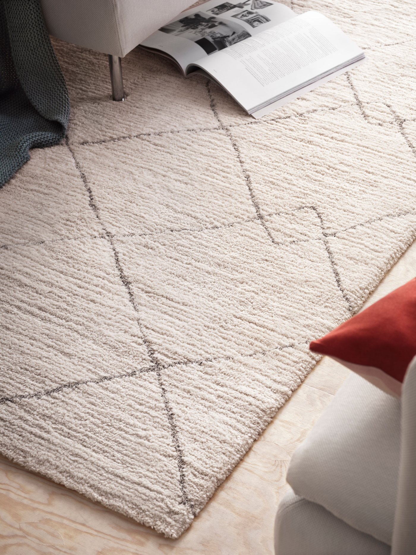 A beige TVERSTED rug, low pile in a close up image in a living room