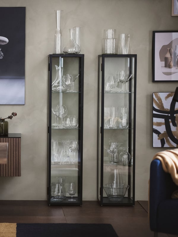 A black BLÅLIDEN glass-door cabinet in the living room