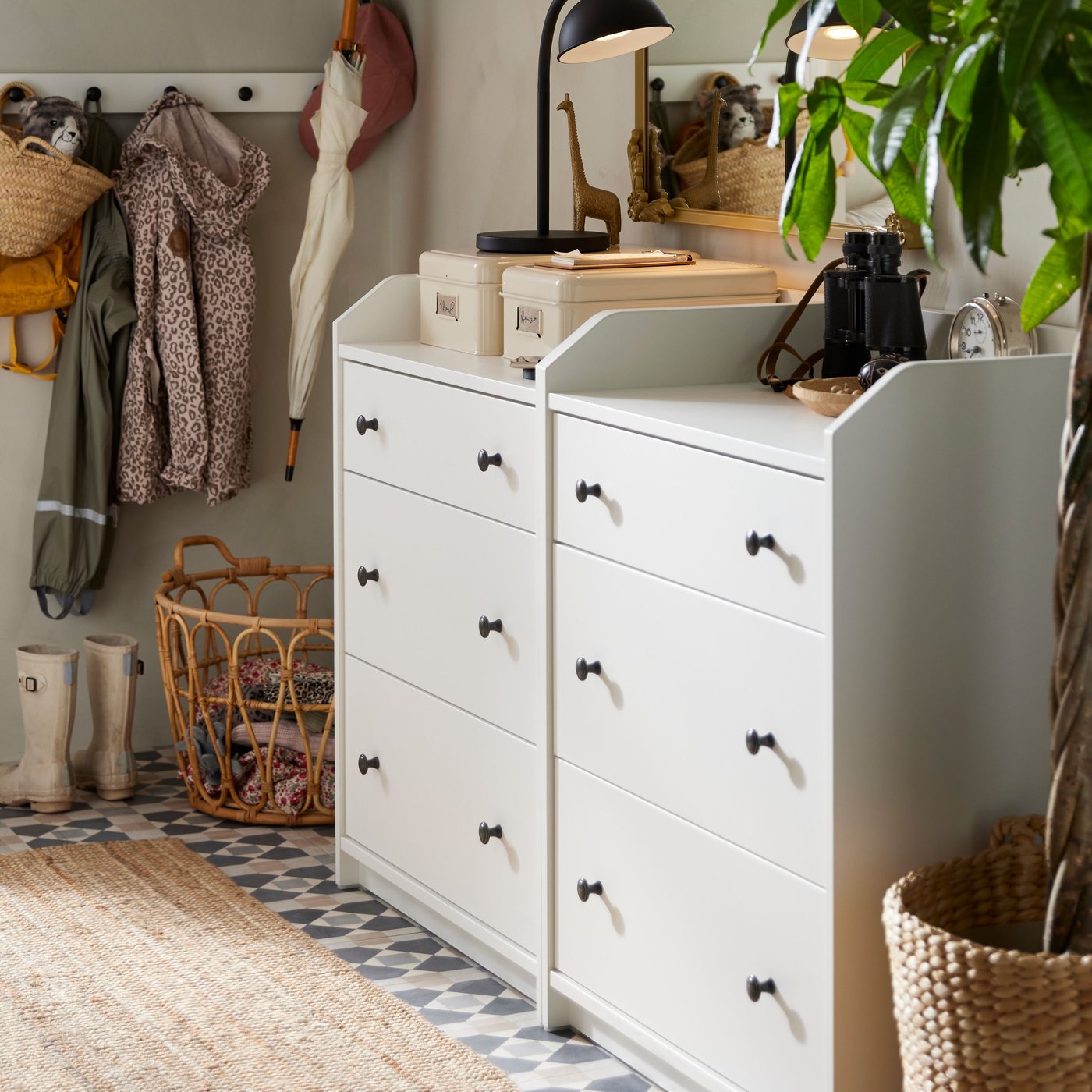 White HAUGA dresser in hallway with boxes and a lamp on top.