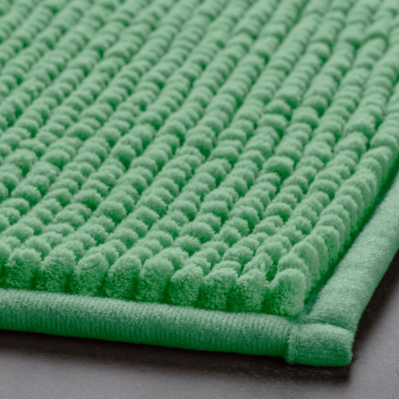 A light green TOFTBO bath mat