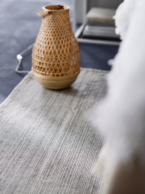 A bamboo/handmade MISTERHULT table lamp in the bedroom