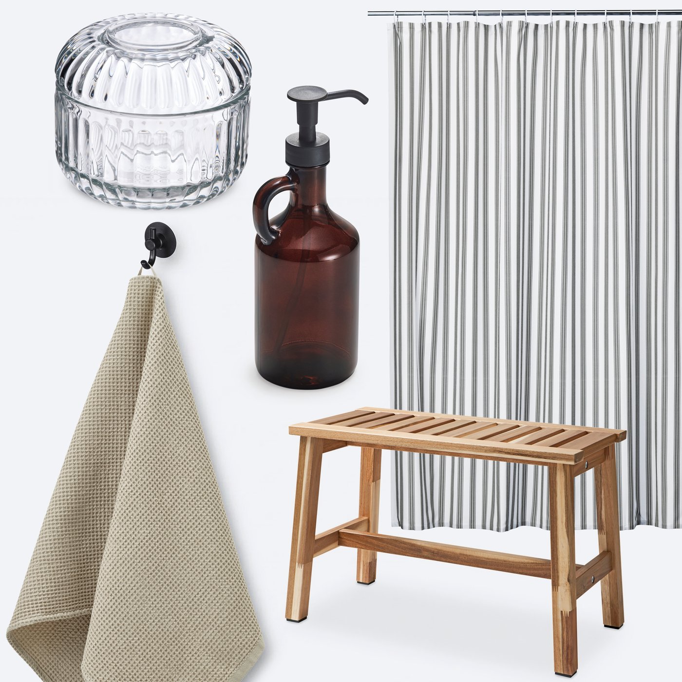 A bathroom with a STAVBJÖRNBÄR shower curtain next to a wooden bench and a glass jar.