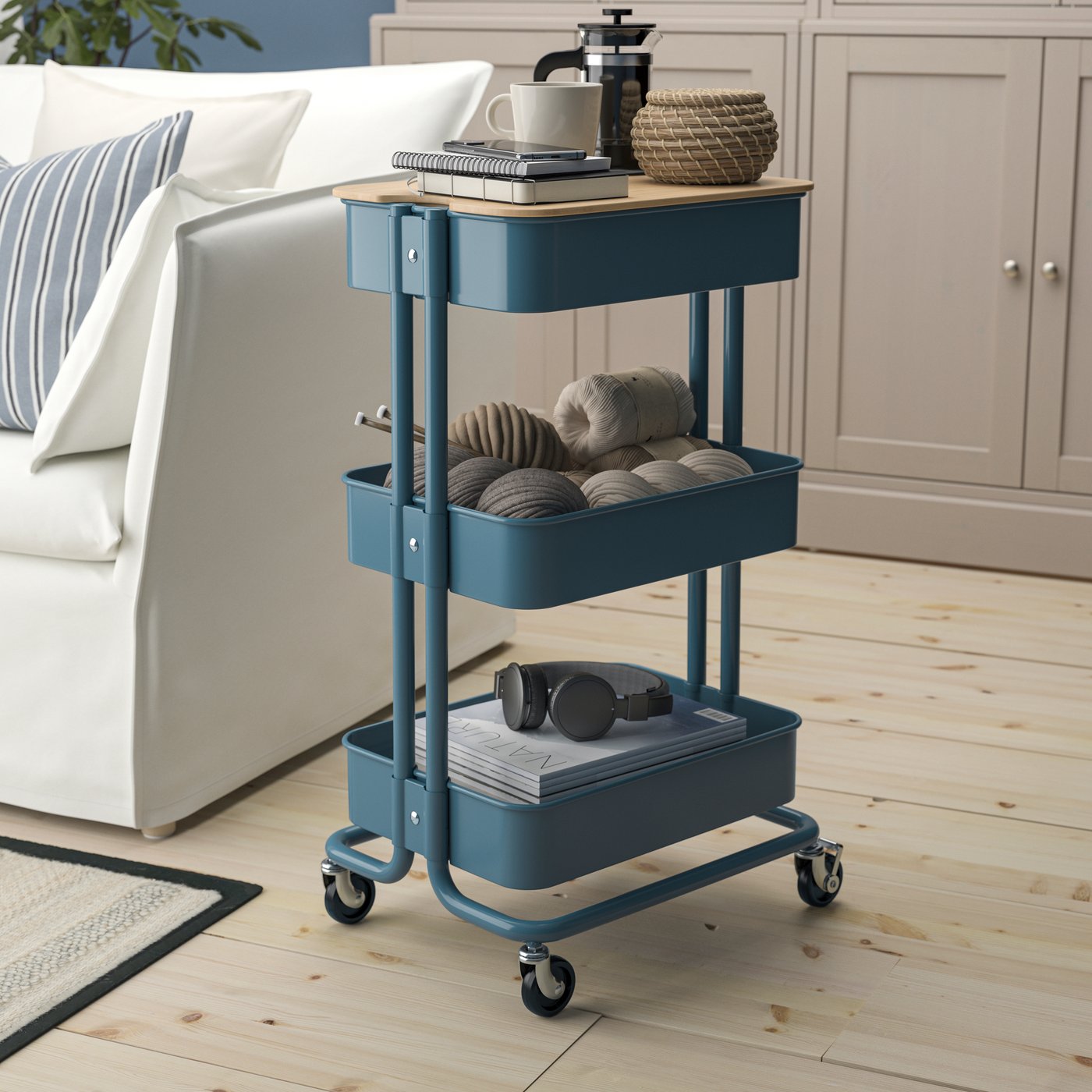 A grey-blue RÅSKOG trolley with lid