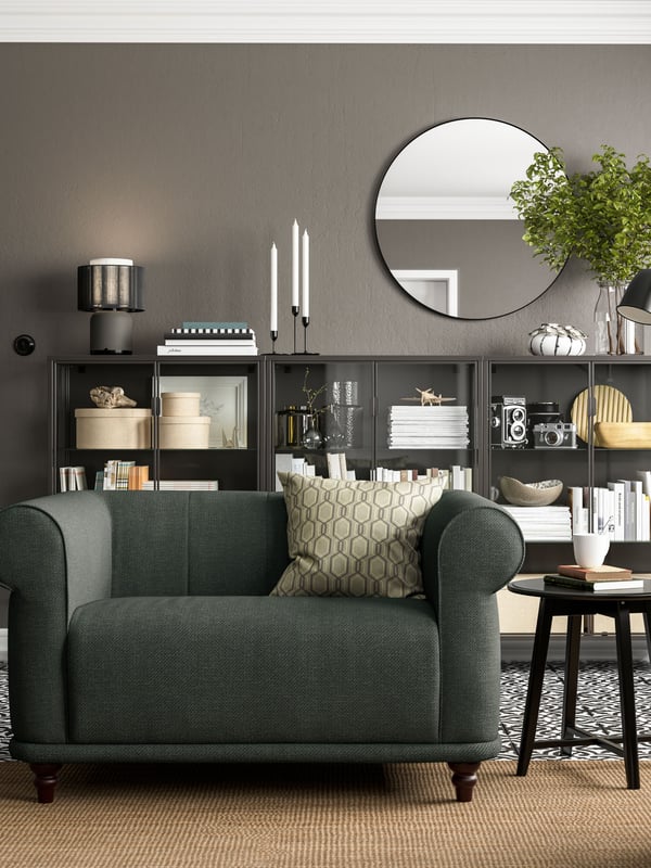 A dark grey VISKAFORS sofa in classic style in a living room with grey walls.