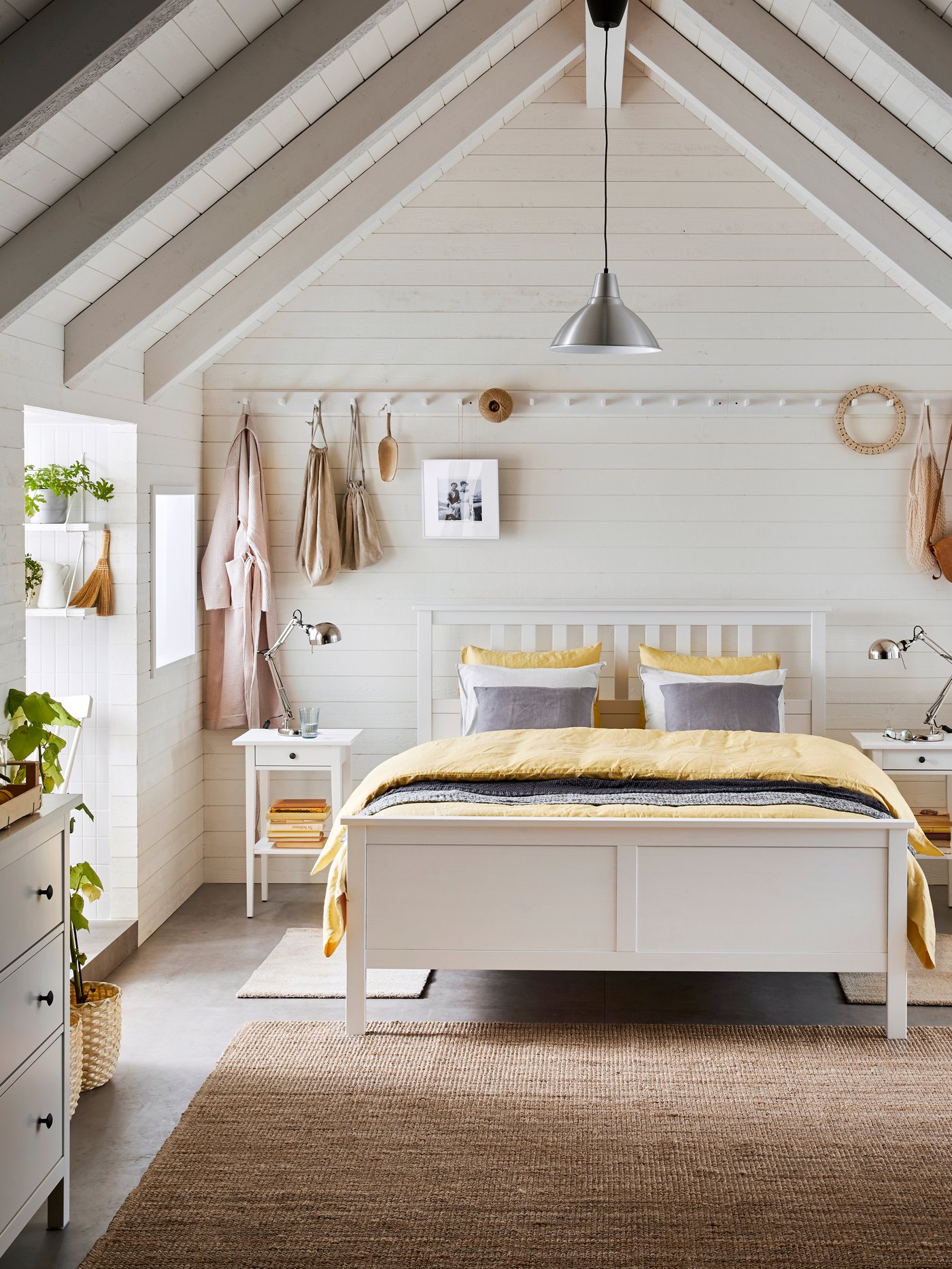 A white KUBBIS rack with 7 hooks in the bedroom
