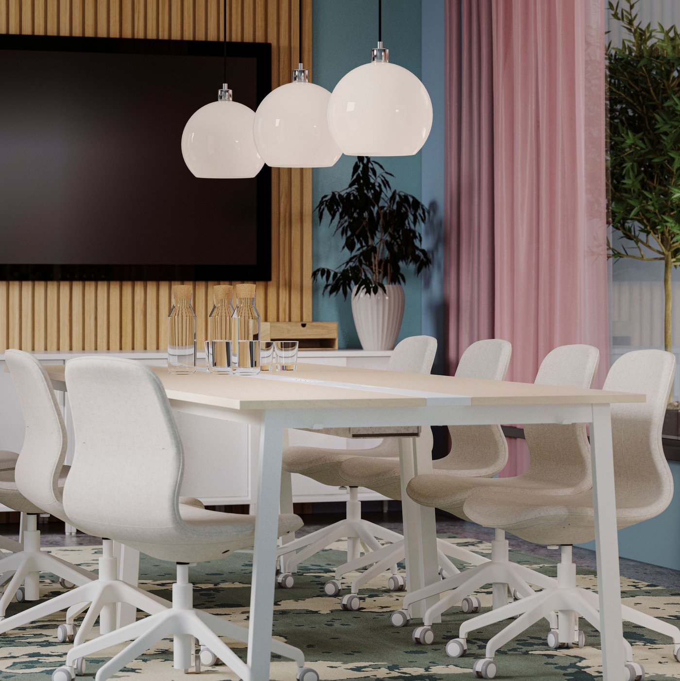 A modern meeting room has two birch veneer/white MITTZON conference tables and beige conference chairs by a large TV screen.