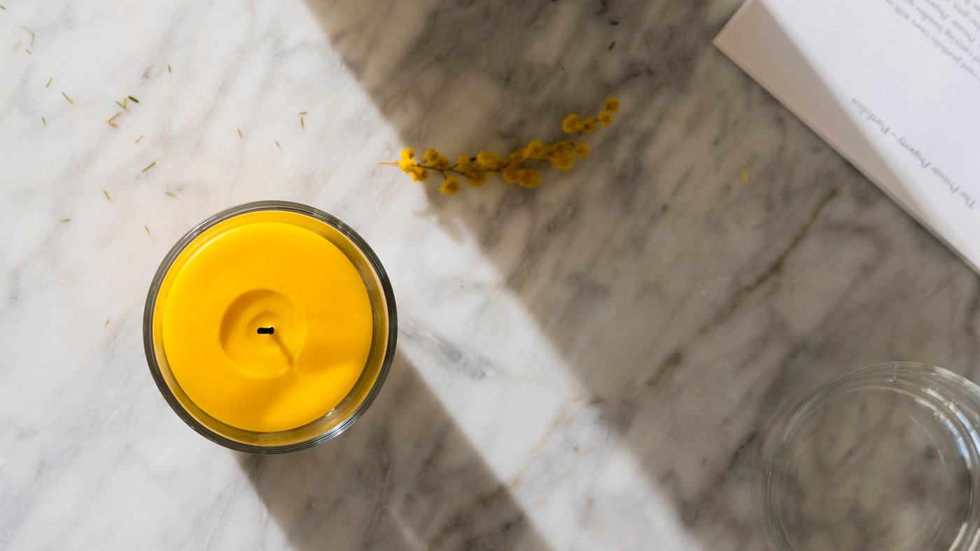 A Mimosa/yellow SVARTOXBÄR scented candle in glass