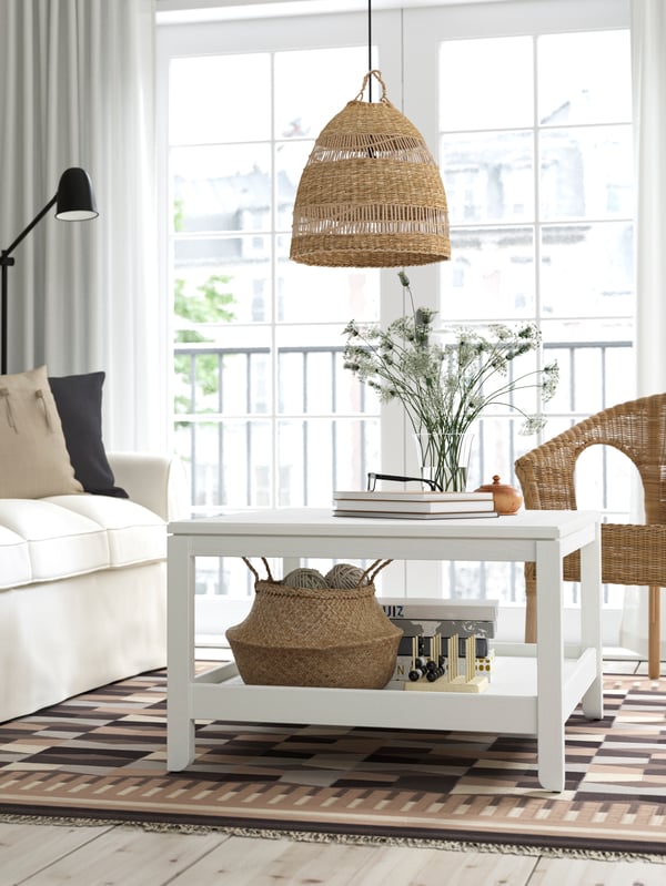 A white HAVSTA coffee table stands in front of a sofa in a light and airy living room with large windows.