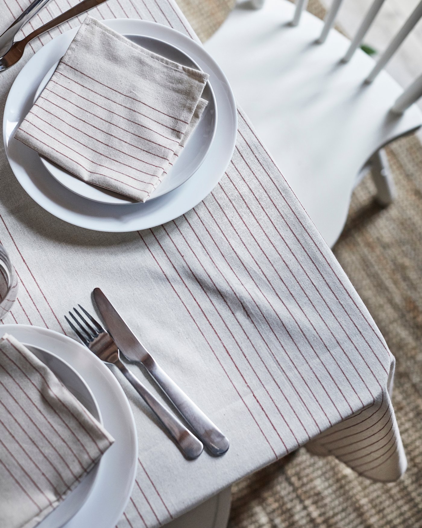 A stripe pattern red/natural VIPPSTARR napkin in the dining room