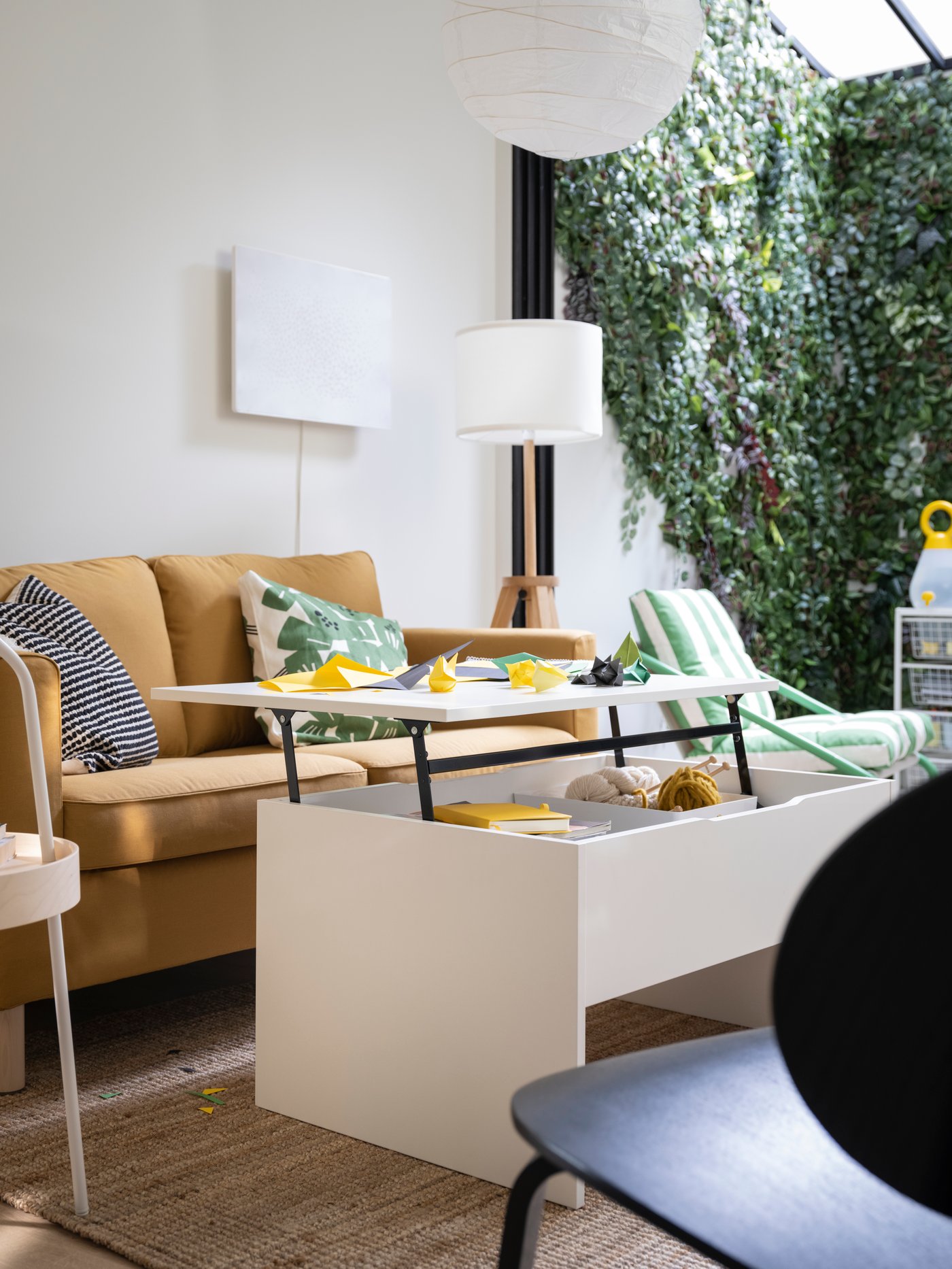 A white ÖSTAVALL adjustable coffee table in the living room