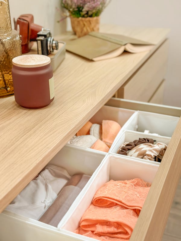 A white SKUBB box in the bedroom