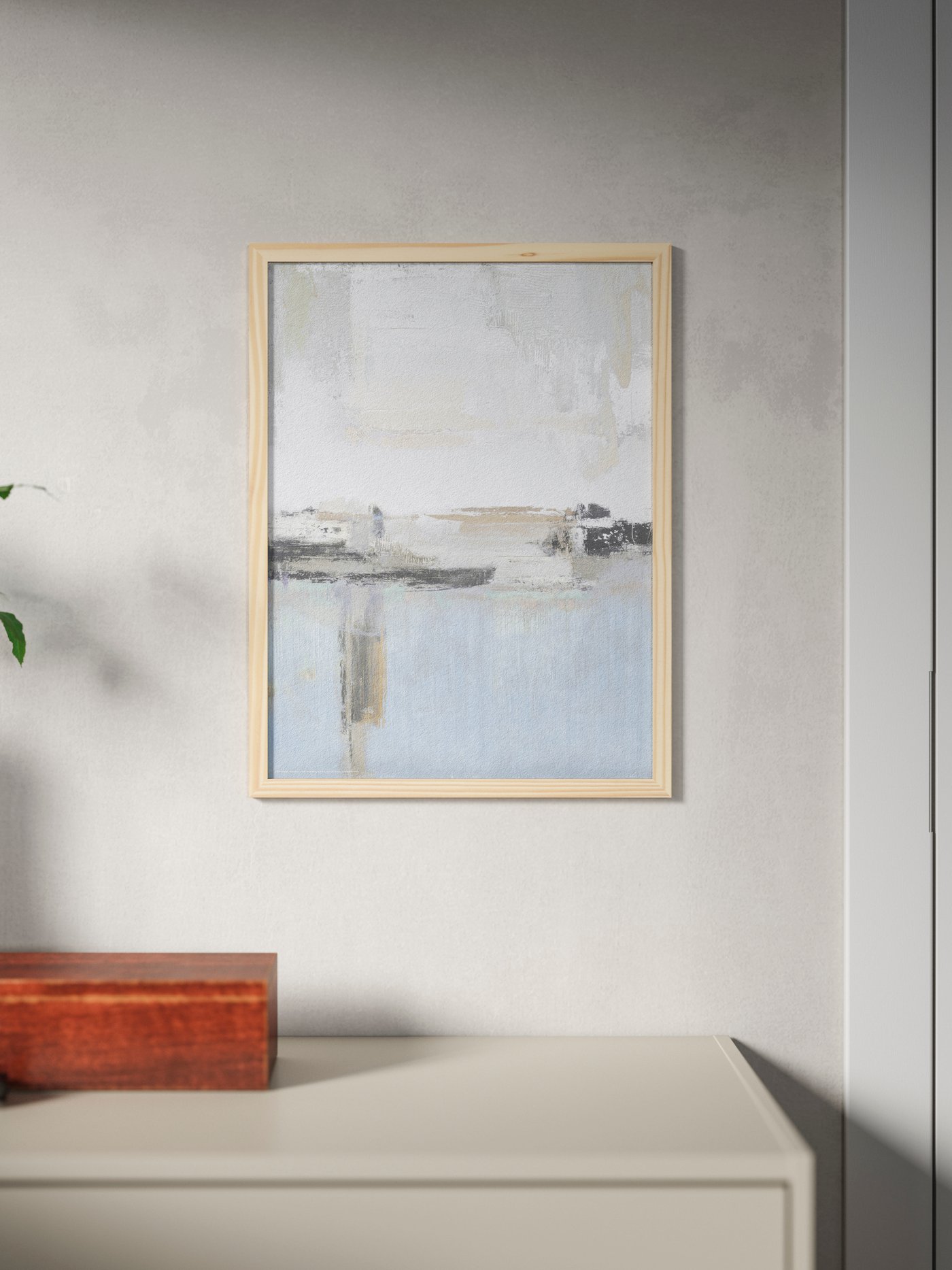 HÄCKHAGTORN picture frame in pine wood, mounted on the wall on top of a sideboard.