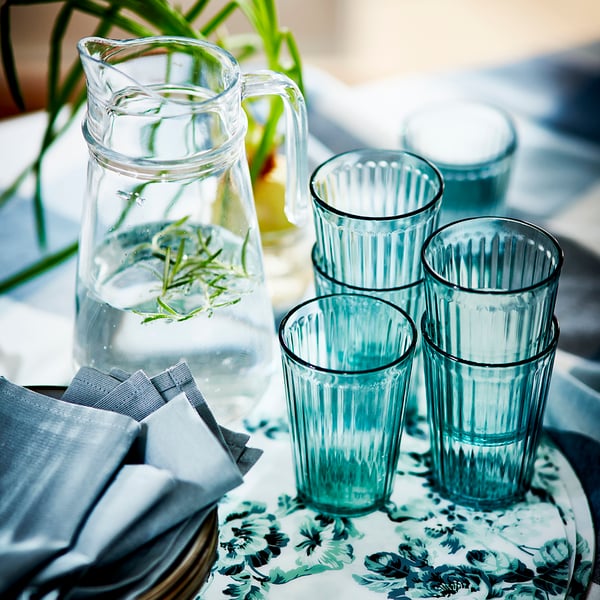 A green KALLNA glass in the dining room