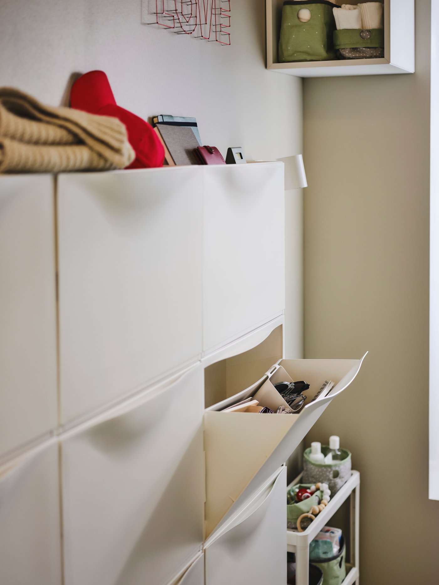 A white TRONES shoe cabinet/storage in the hallway