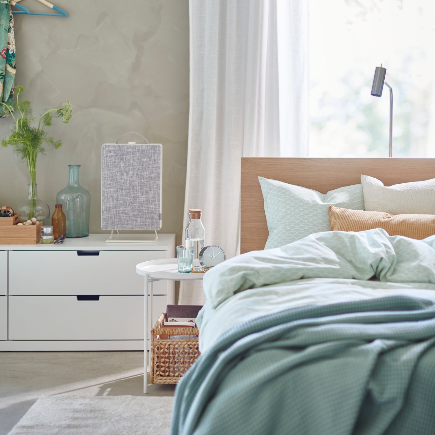 A white FÖRNUFTIG air purifier in the bedroom