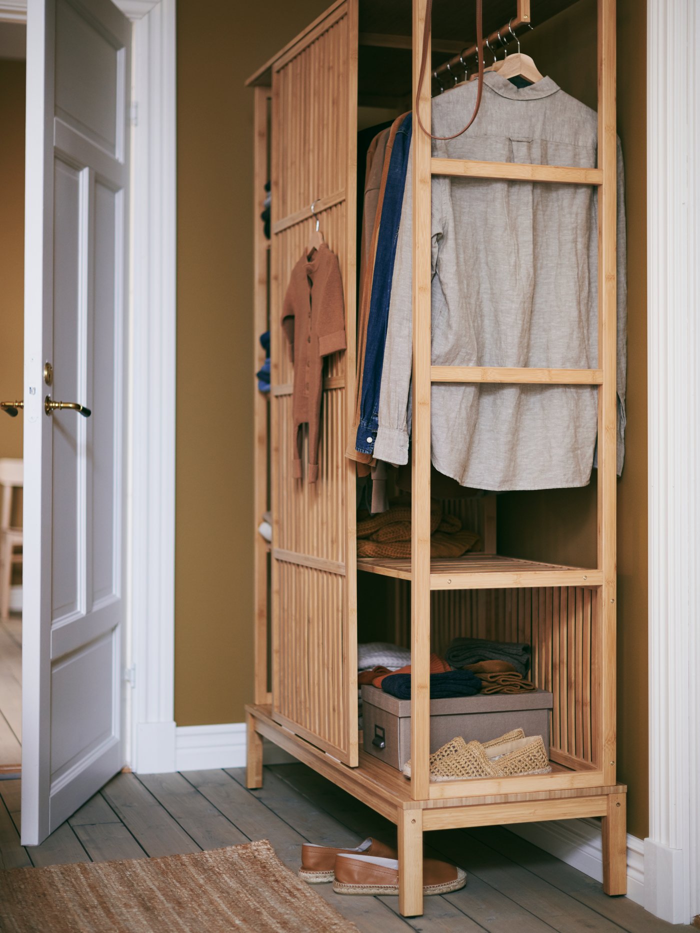 A bamboo NORDKISA open wardrobe with sliding door in the bedroom