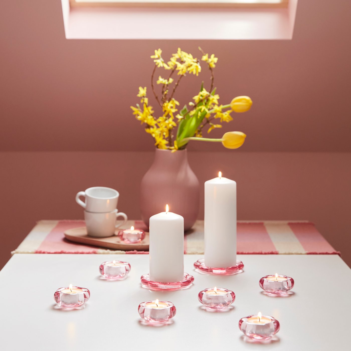 A white FENOMEN unscented pillar candle