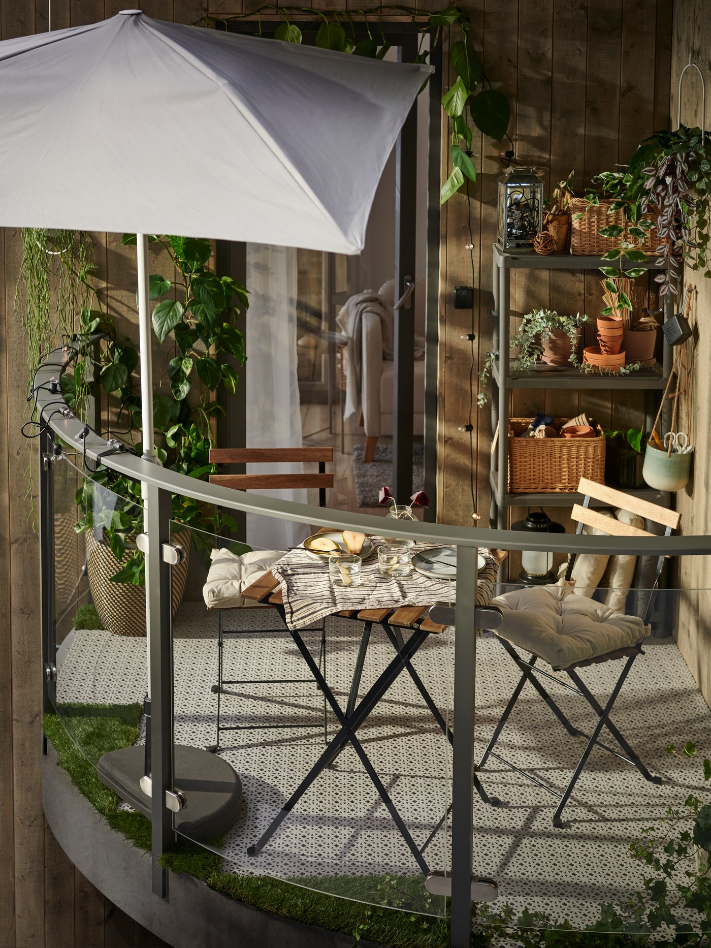 An in/outdoor dark grey/beige RÅGKORN plant pot outside