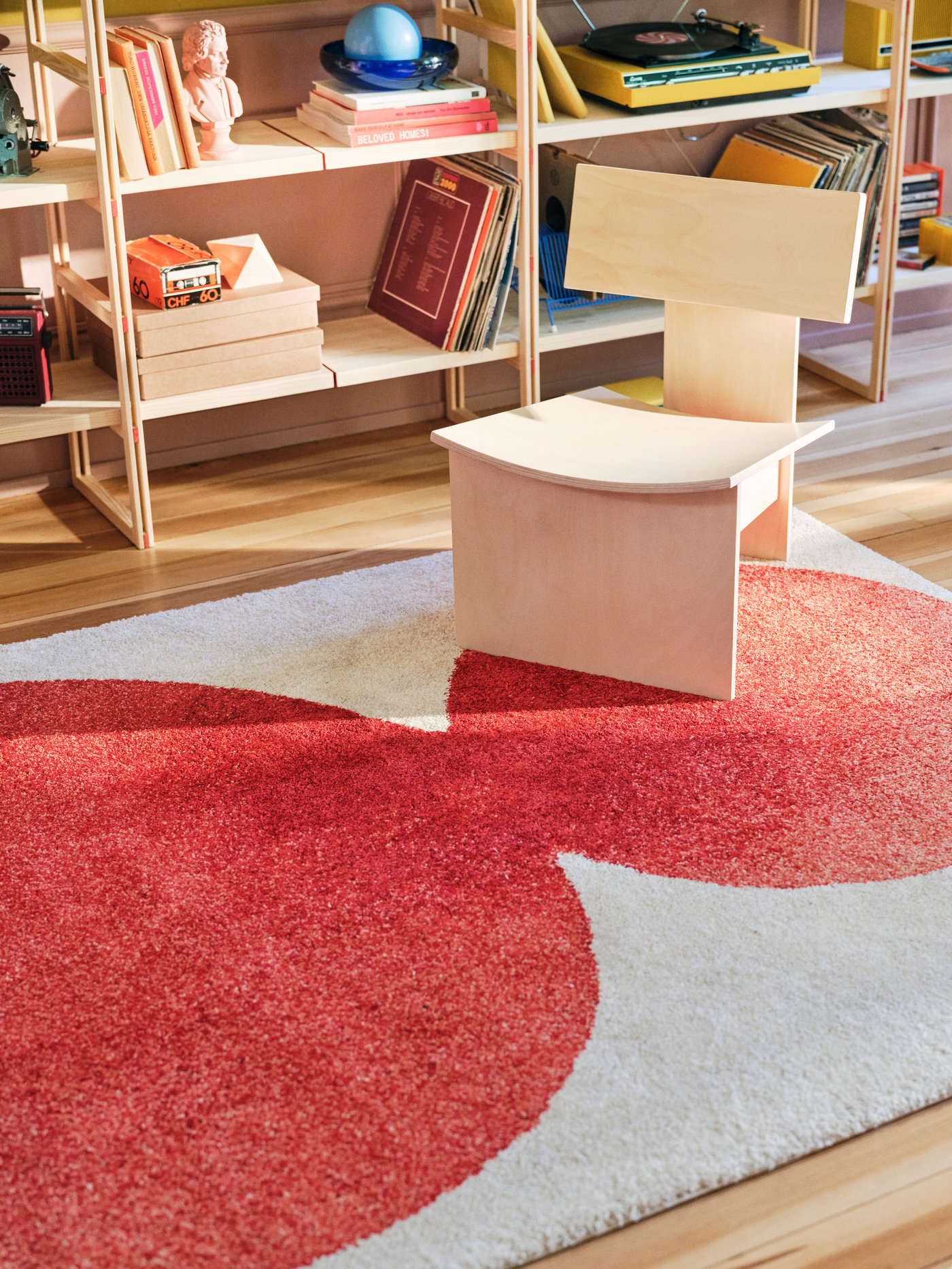 An off-white/red IKEA PS 2026 rug, low pile in the living room