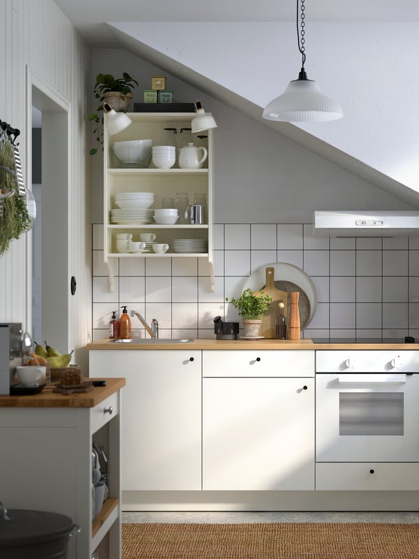 An off-white/oak TORNVIKEN kitchen island in the kitchen