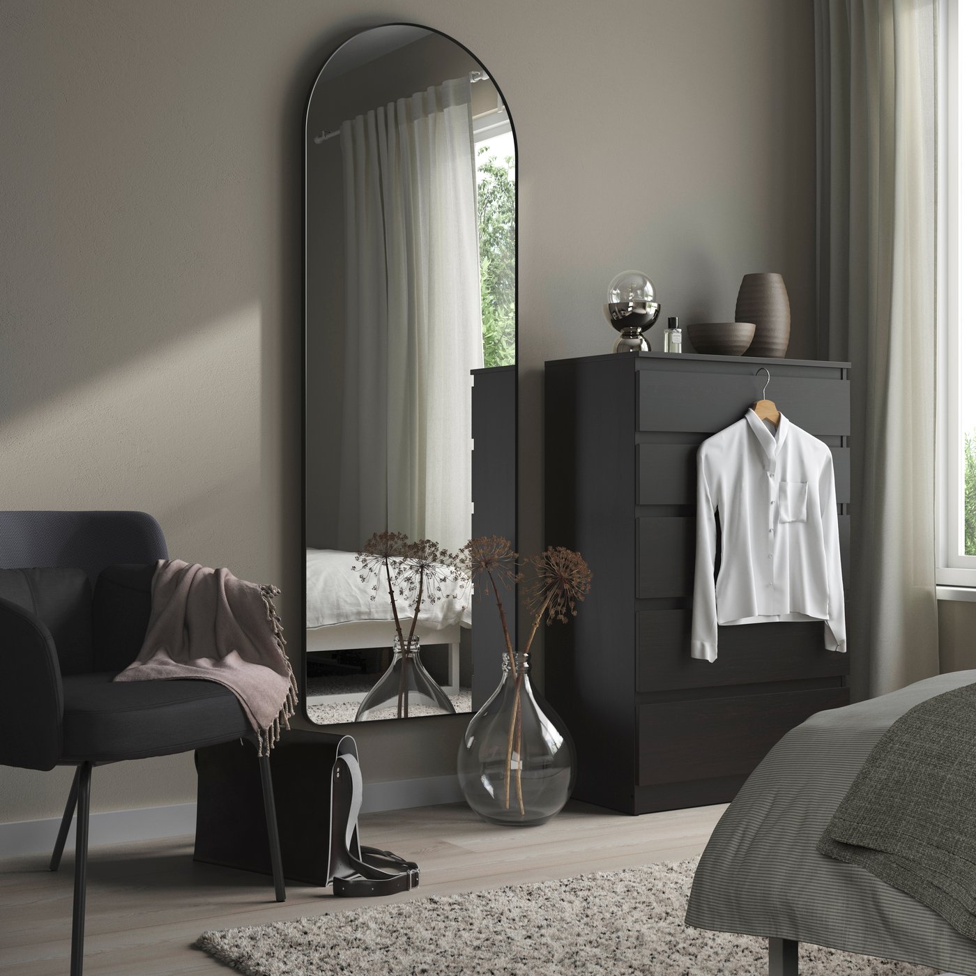 A black LINDBYN mirror in the bedroom