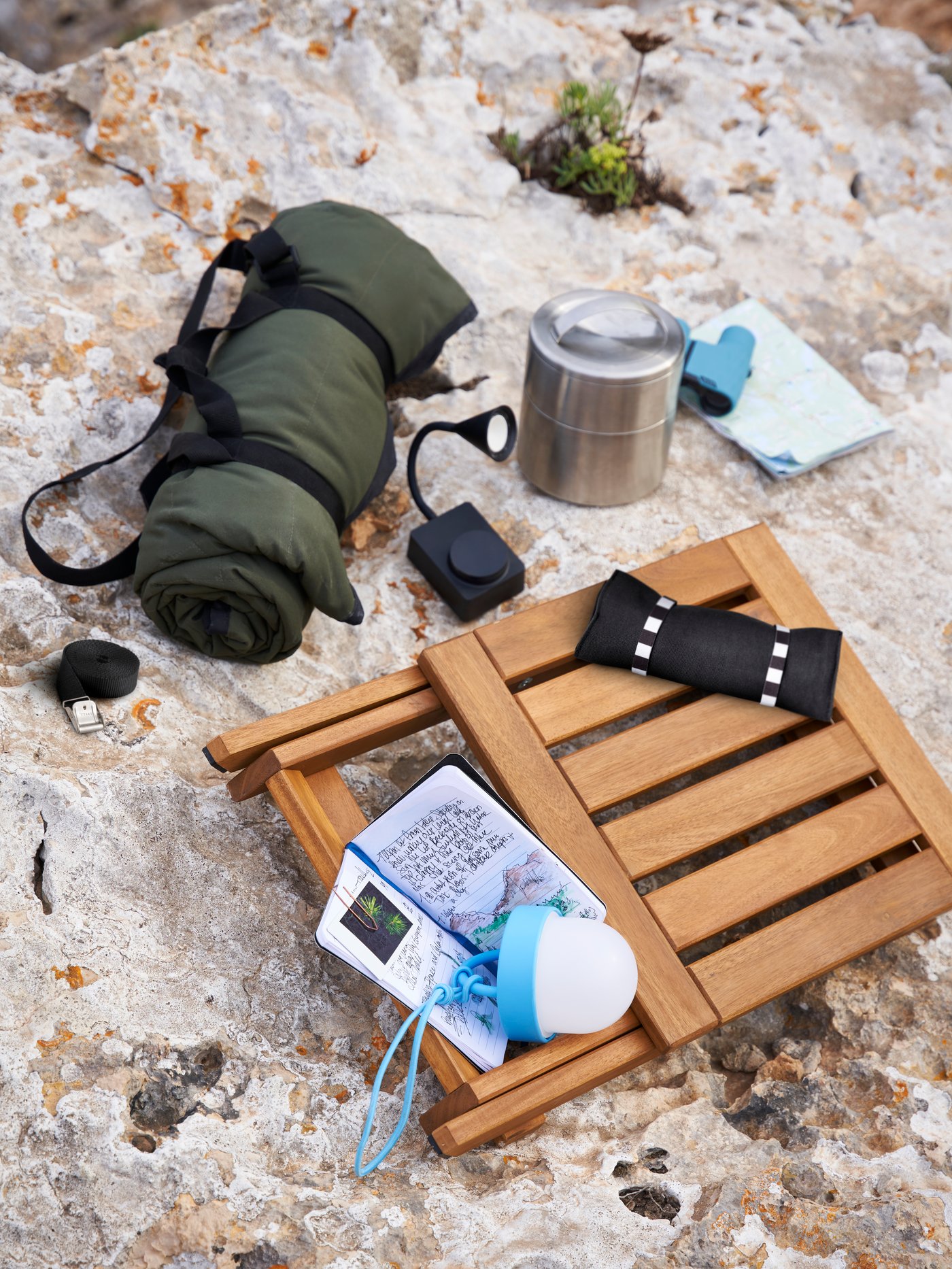 A battery-operated outdoor/dimmable black TÅGVIRKE LED spotlight and clamp