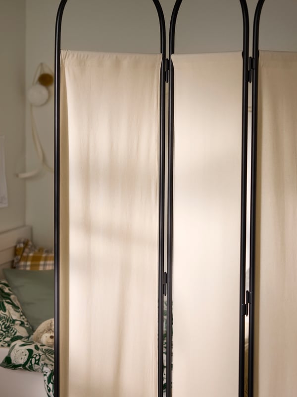 Close-up of GRÅFJÄLLET room divider in anthracite with beige fabric.