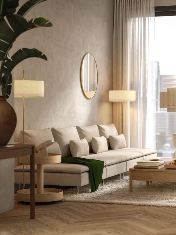 A white textile/brass-plated STOCKHOLM 2025 floor lamp in the living room