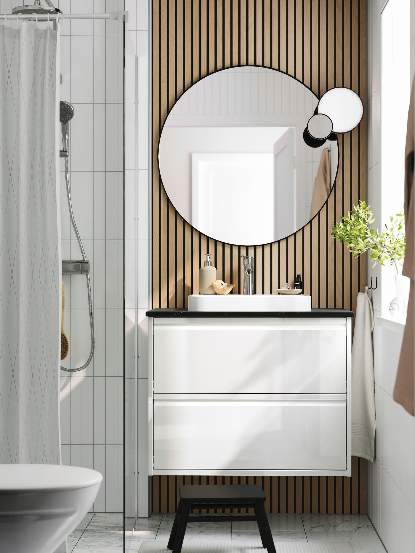 A high-gloss white/black marble effect BACKSJÖN wash-stnd w drawers/wash-basin/tap in the bathroom