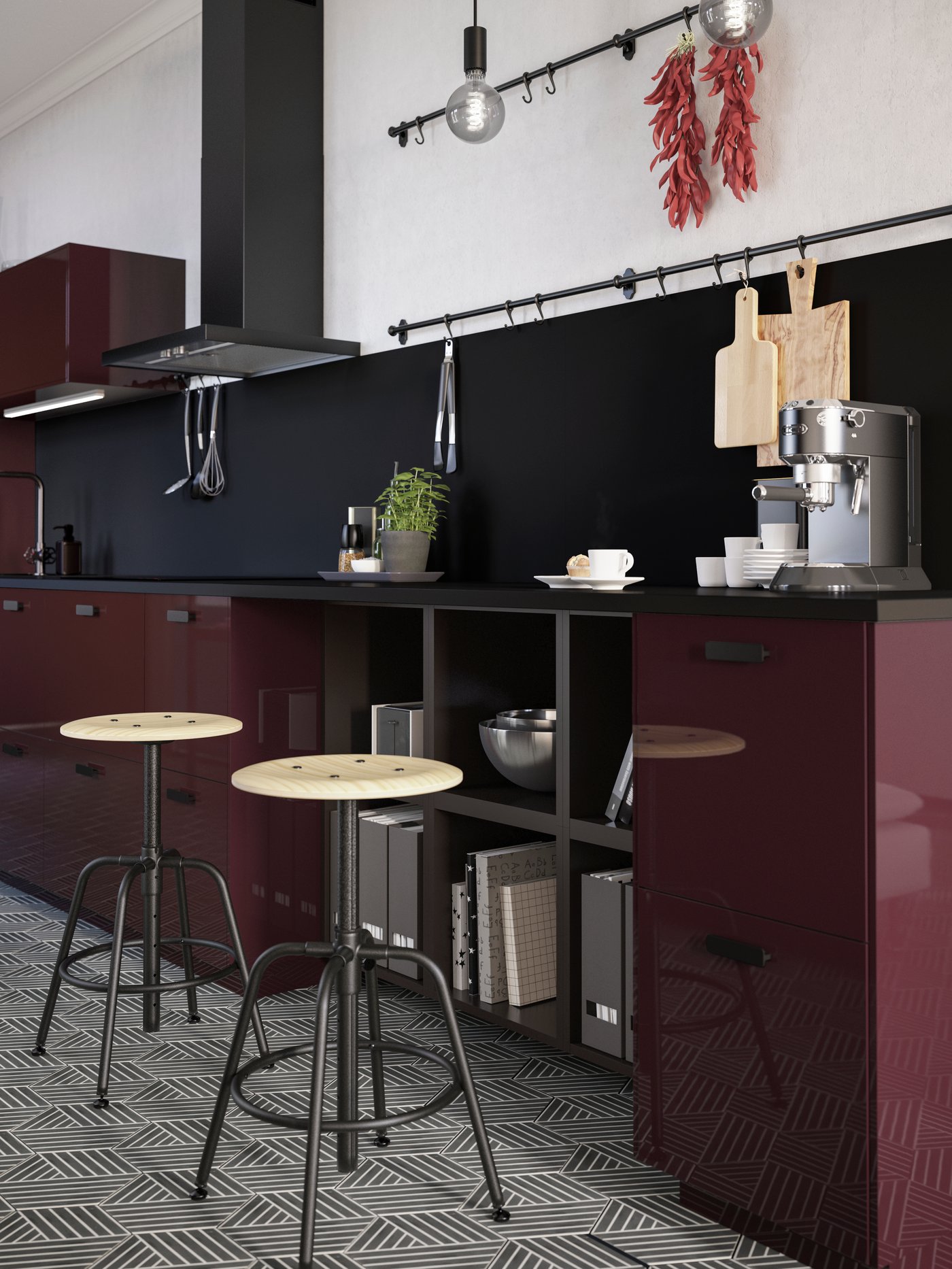 Two stools in pine/black stand by a kitchen countertop in a burgundy kitchen. A coffee machine and some mugs are on top.