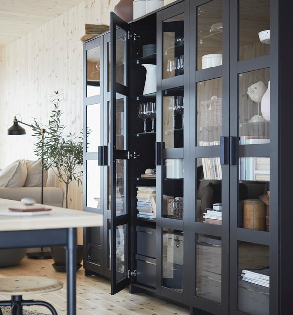 A black BRIMNES glass-door cabinet in the living room