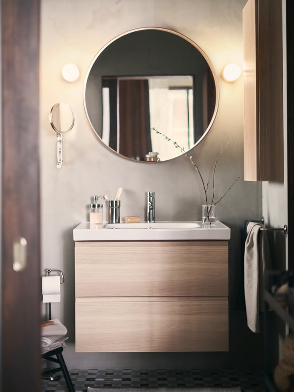 A chrome-plated KALKGRUND toothbrush holder